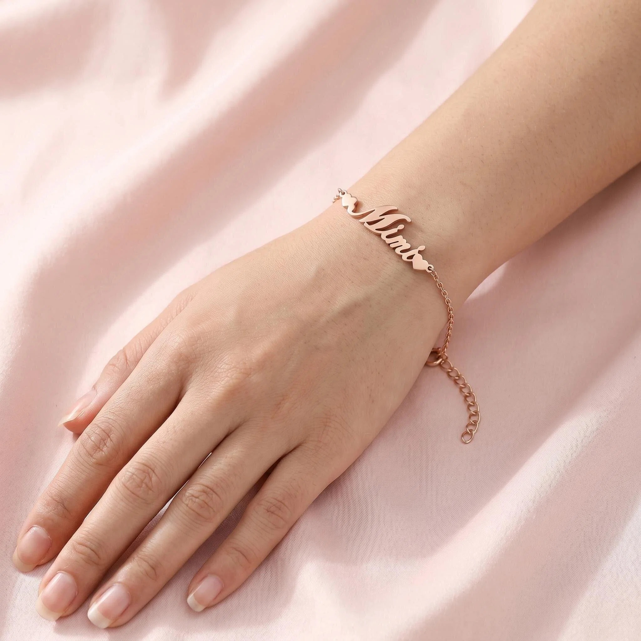 Rose gold name bracelet worn on wrist