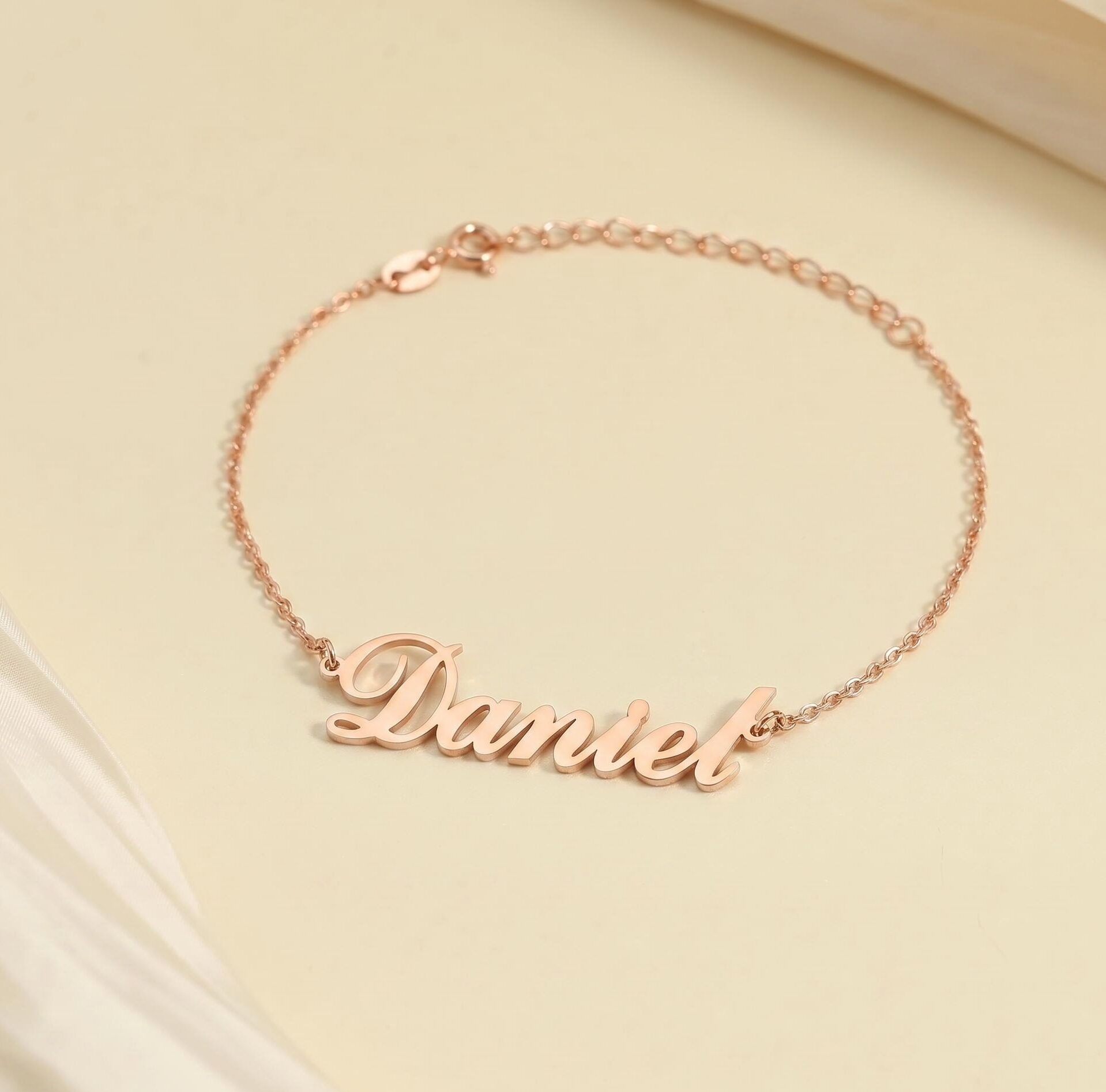 Custom name bracelet — personalized name jewelry extending the nameplate tradition to the wrist